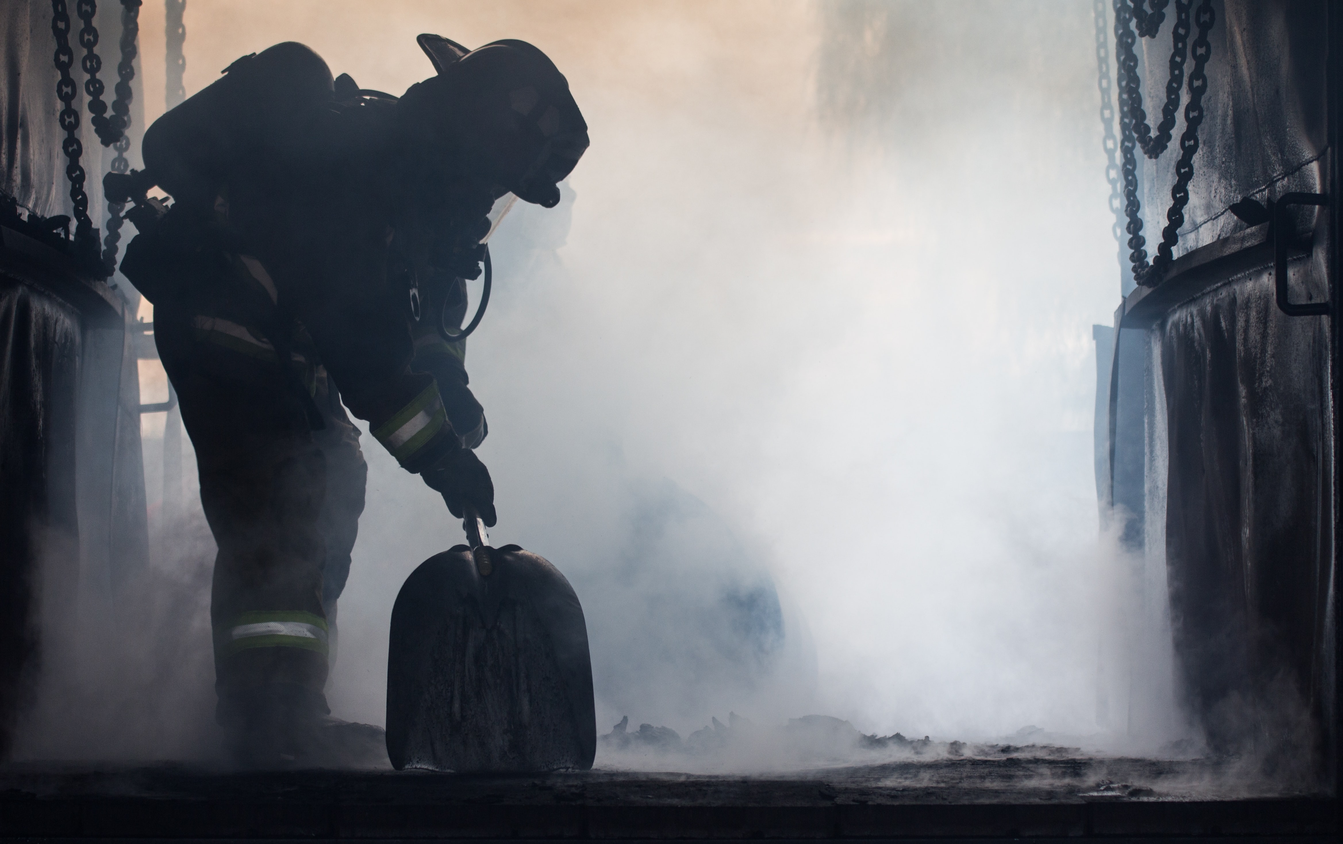Firefighter during an intervention in the smoke