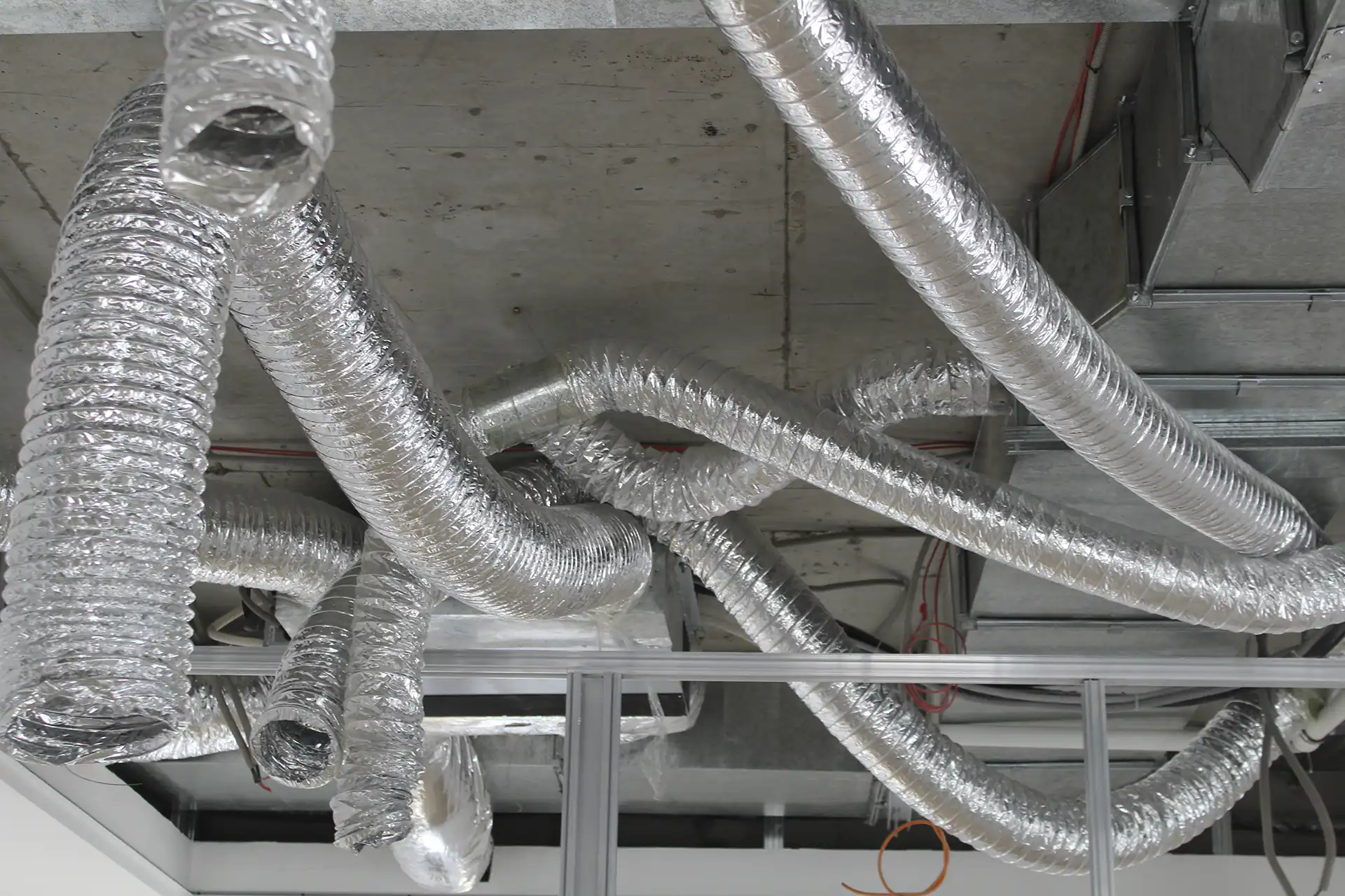 employees setting up a ducting network made of aluminium
